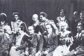 Participants of the dress rehearsal of "The Queen of Spades". They sit (from left to right): V.E. Meyerhold, S.A. Samosud, S.N. Gisin, R.A. Shapiro, N.L. Welter, N.I. Kowalski. Among those standing (in the center) - LT. Chupyatov. (   " ".  ( ): .. , .. , .. , .. , .. , .. .   ( ) - .. .) (Belyaev)